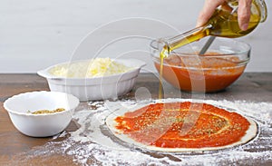 Pizza dough with fresh tmato sauce and oregano. Italian traditional recipe of pizza