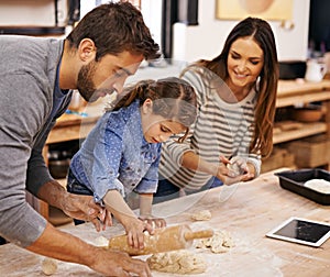 Pizza, dough and parents with child in kitchen and tablet for recipe, guide and learning together. Family, cooking and