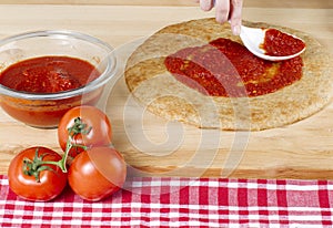 Pizza dough with red sauce