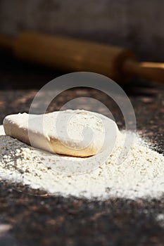 Pizza dough before rolling into a circle. The process of making homemade pizza dough. The concept of homemade fast food.