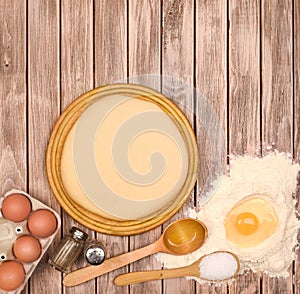 Pizza dough On wooden background.