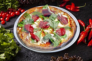 Pizza, dried tomatoes, arugula