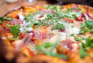 Pizza with dry cured ham and arugula