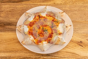 Star-shaped pizza with grated cream photo