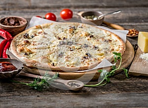 Pizza with four cheeses, pears and nuts