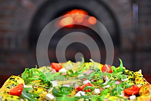 Pizza in front of a stone stove