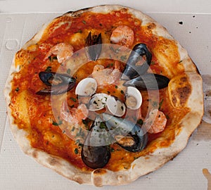 Pizza `frutti di mare` with mussels, clams and shrimps photo