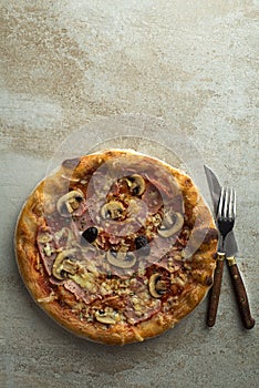 Pizza with ham, cheese and mushrooms