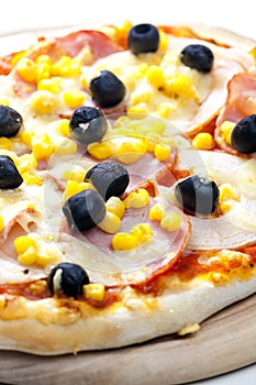 pizza with ham, corn and olives