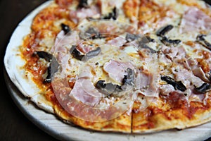 Pizza ham and mushroom on wood