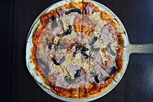 Pizza ham and mushroom on wood