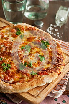 Pizza ham and mushroom on wooden table