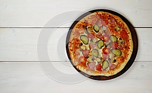 Pizza with ham, mushrooms, cherry tomatoes and pickles on a white background