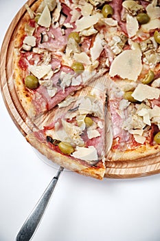 Pizza with ham, olives, mushroom and Parmesan isolated on white