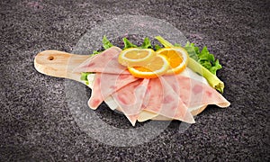 Pizza ham sliced on wooden board with clipping path