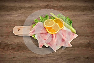 Pizza ham sliced on wooden board with clipping path