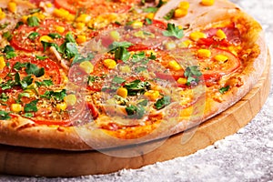 Pizza with ham, tomatoes and corn