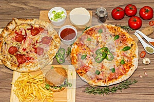 Pizza and hamburger on wooden background