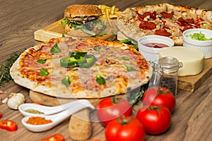 Pizza and hamburger on wooden background