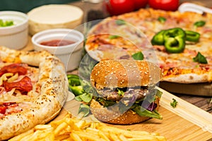 Pizza and hamburger on wooden background