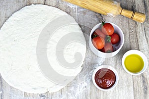 Pizza ingredients on yellow background