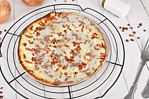 Pizza-like food called `Tarte Flambee` or `Flammkuchen`