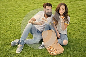 Pizza lovers. happy couple eating pizza. couple in love dating. fast food. bearded man hipster and adorable girl eat