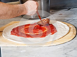 Pizza Maker puts on the sauce