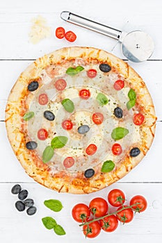 Pizza margarita margherita from above baking ingredients on wooden board portrait format