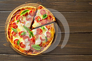 Pizza Margherita over wooden background