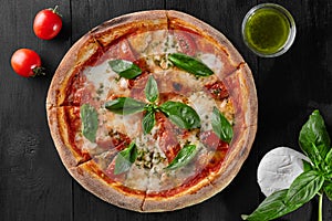 Pizza Margherita with tomatoes, mozzarella cheese and basil