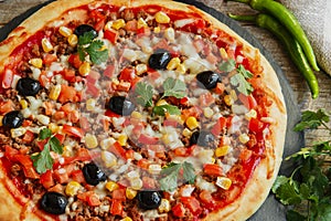 Pizza with minced meat tomato cheese corn olives