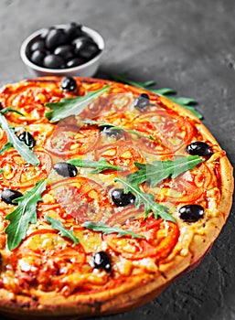 Pizza with Mozzarella cheese, Tomatoes, pepper, olive, Spices and Fresh arugula. Italian pizza. Pizza Margherita or Margarita