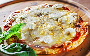 Pizza with Mozzarella cheese, Tomatoes, pepper, Spices and Fresh Basil. Italian pizza. Pizza Margherita or Margarita on wooden tab