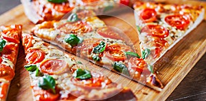 Pizza with Mozzarella cheese, Tomatoes, pepper, Spices and Fresh Basil. Italian pizza. Pizza Margherita or Margarita on wooden tab