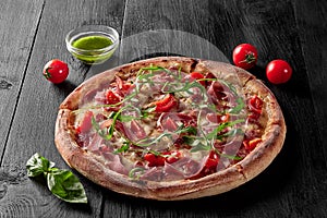 Pizza with pelati sauce, cabanossi, salami, bacon, prosciutto