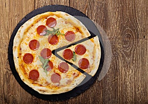 Pizza peperoni on stone black try