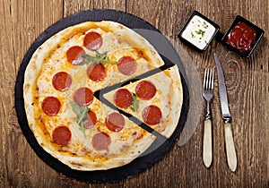 Pizza peperoni on stone black try