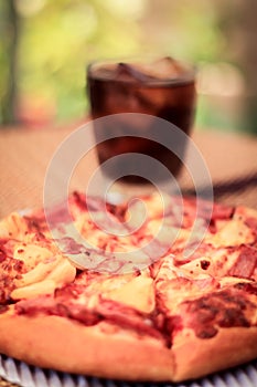 Pizza picture with a glass of sparkling water. Blurred background