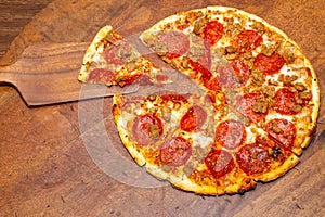 Pizza pie cut in 8 slices with 1 slice removed demonstrating fractions.