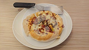 Pizza with pineapple, sausages and mushrooms