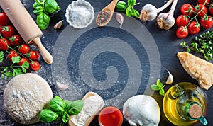 Pizza Preparation With Ingredients On Black Table