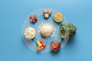 Pizza primavera ingredients and dough, top view. Pizza with vegetables and cheese making of recipe