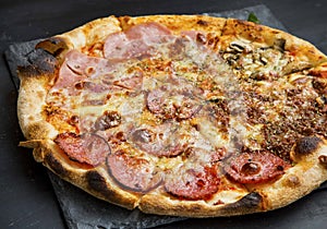 Pizza quatro stagione with salami, ham,chicken and cheese photo