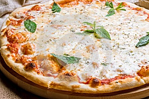 Pizza Quattro formaggi with mint on table