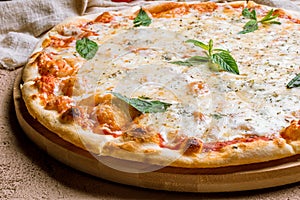 Pizza Quattro formaggi with mint on table