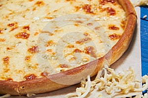 Pizza quattro fromaggi on a wooden board