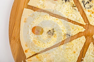 Pizza quattro fromaggi on wooden board