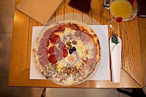 Pizza quattro stagioni with egg served on a plate photo