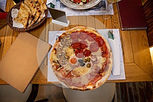 Pizza quattro stagioni with egg served on a plate photo